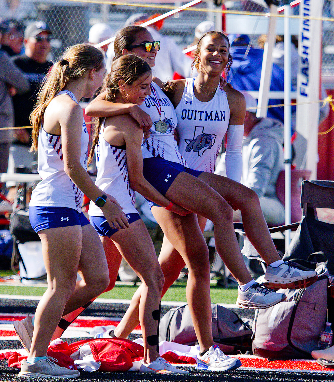 Katie Degorostiza gets an assist from her 4x400m relay teammates, after a long day of running, including  3200m and 1600m runs, both of which she won. [see more speed and strength on display]